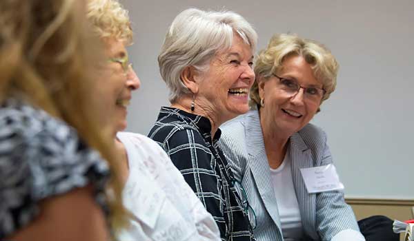 a group of people looking at a woman