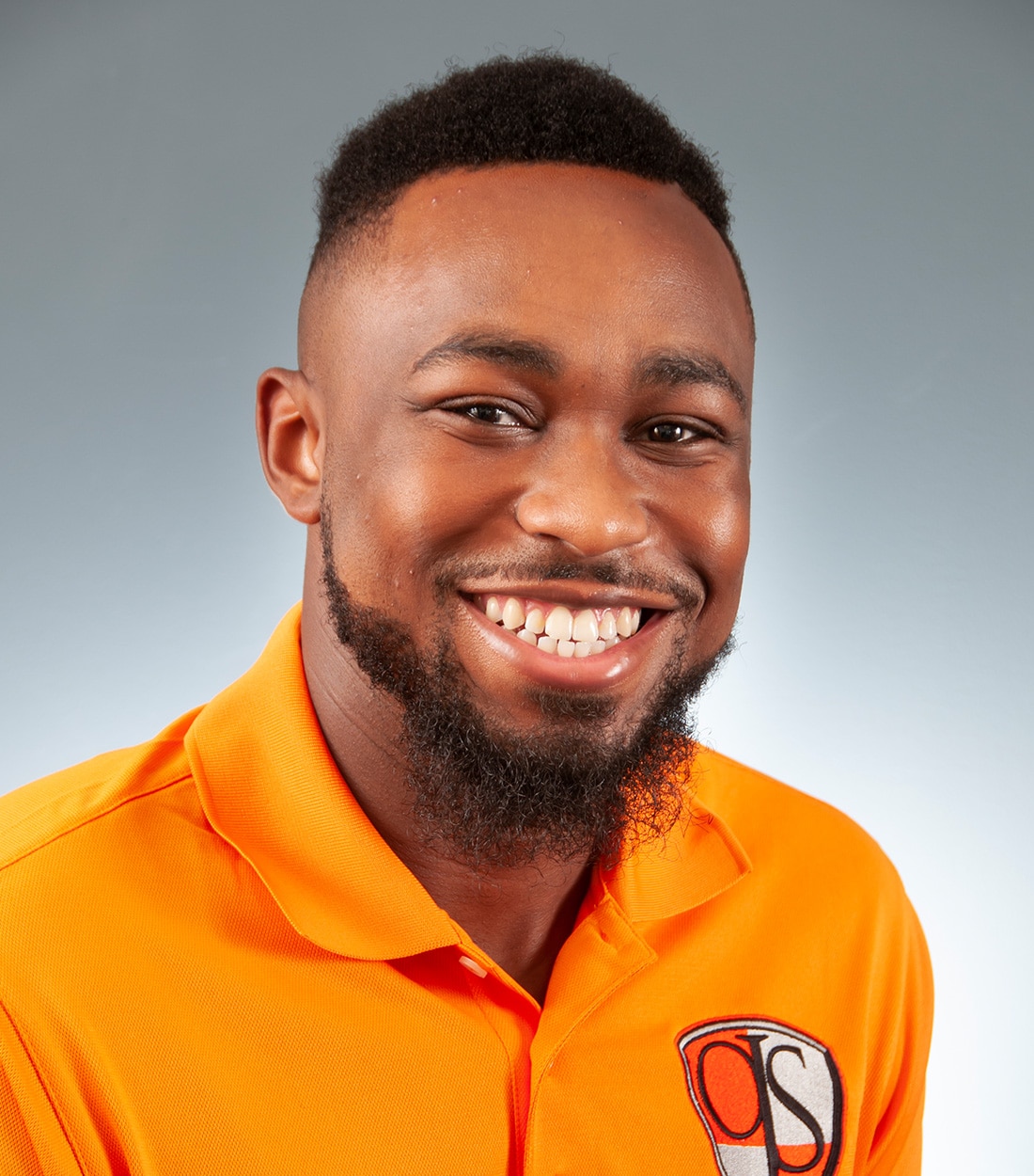 a man wearing an orange shirt
