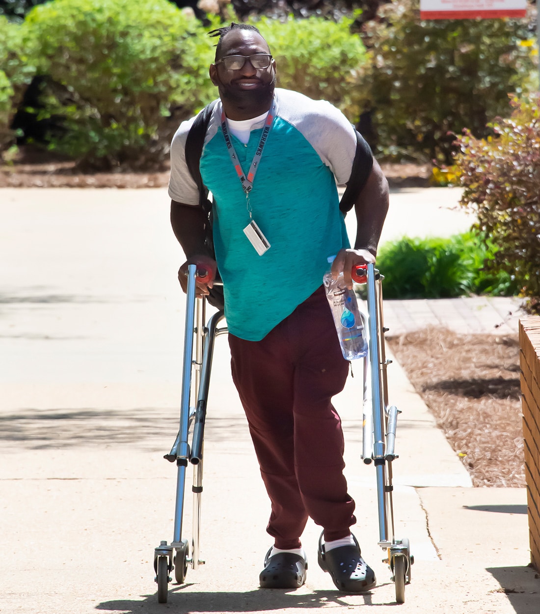 a student walks down the sidewalk