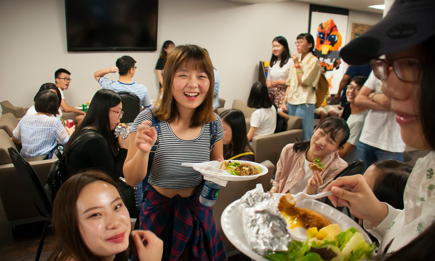 a group of people sitting at a table with food