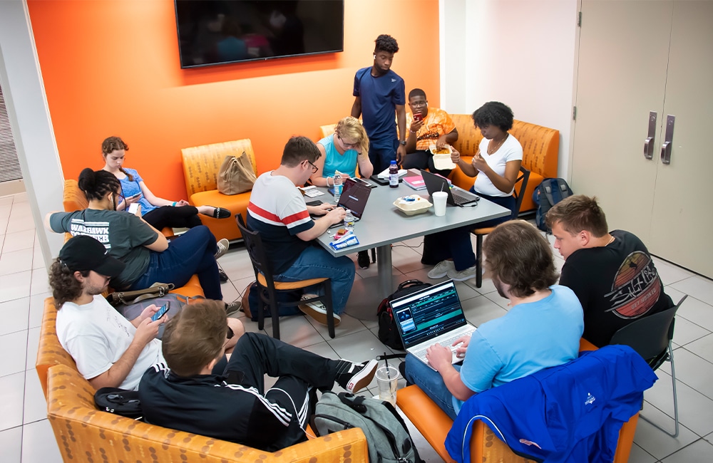 a group of people sitting at a desk