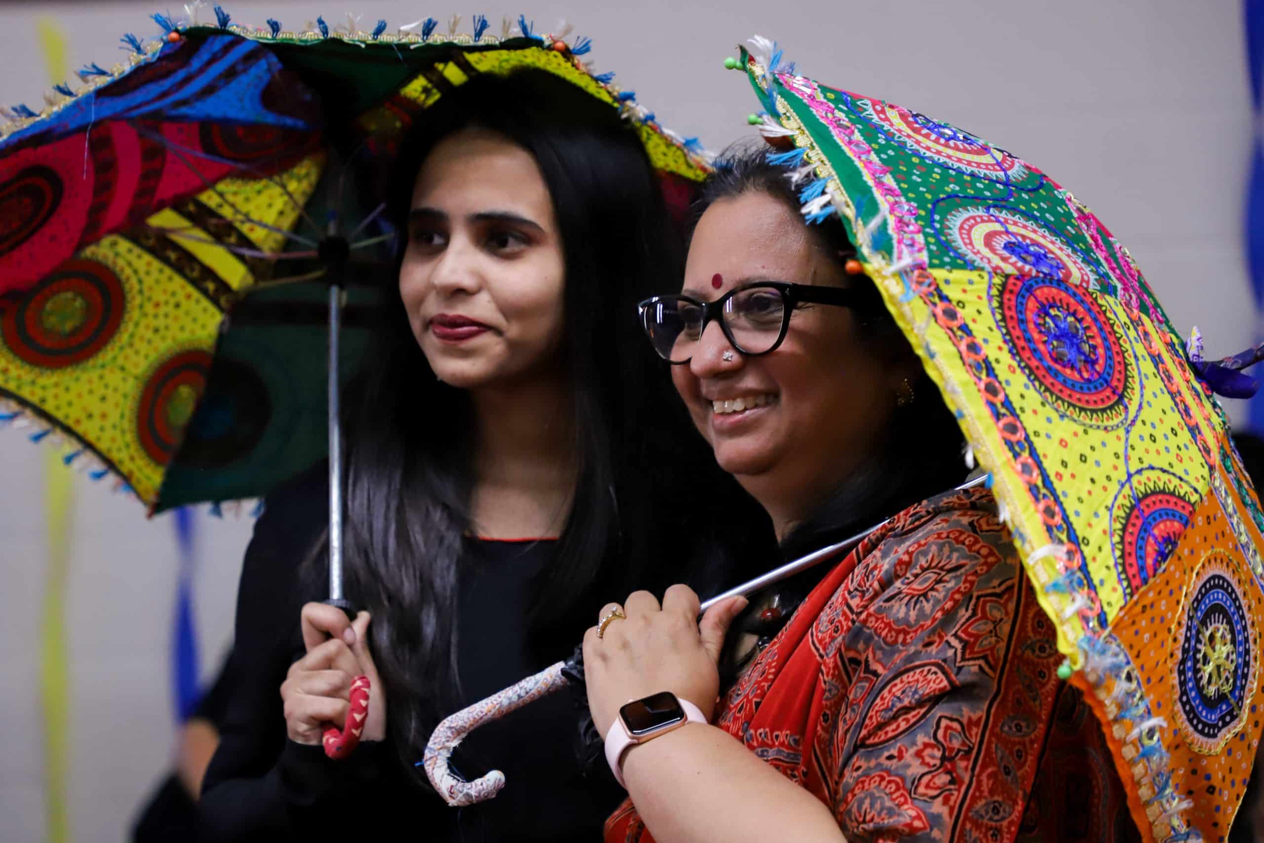 a woman holding a colorful umbrella