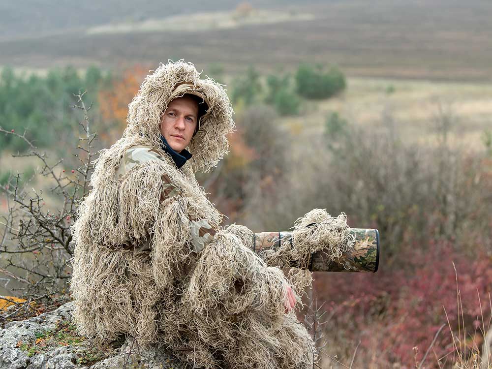 A wildlife photographer taking pictures outside