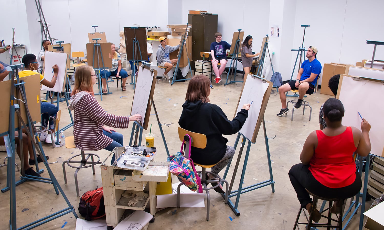 a group of students in a drawing class