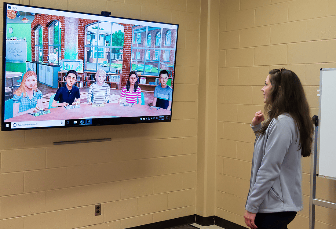 a person standing in front of a television