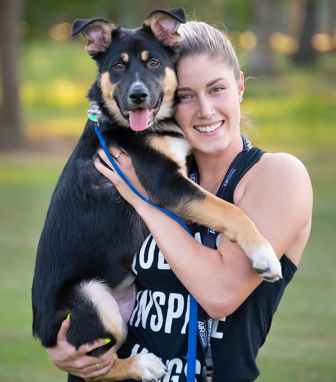 a woman holding a dog