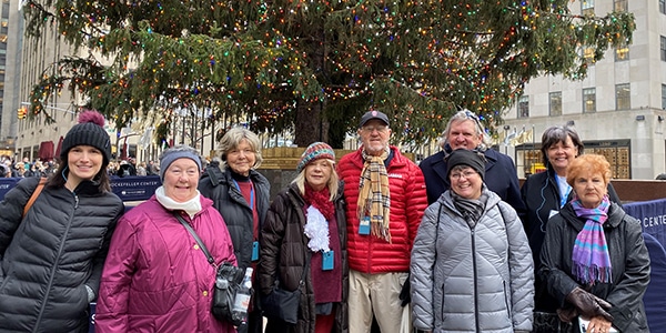 a group of people standing in front of a crowd posing for the camera