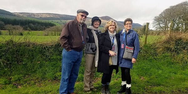 a group of people standing in a field