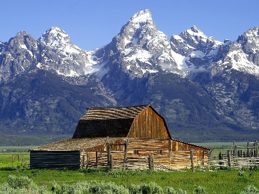a view of a snow covered mountain with Teton Range in the background