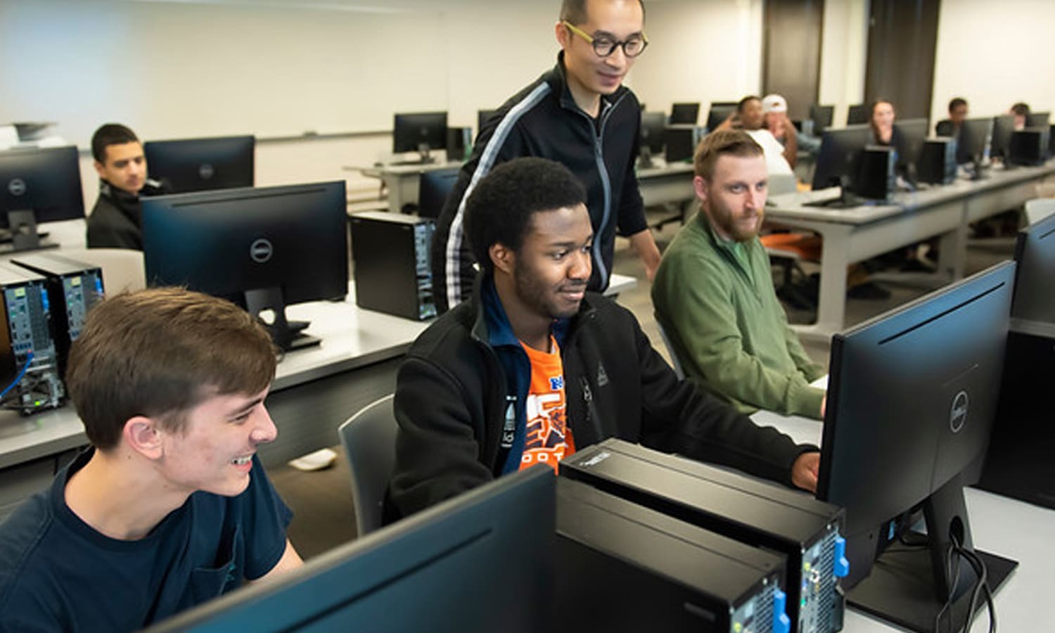 a group of people looking at a computer