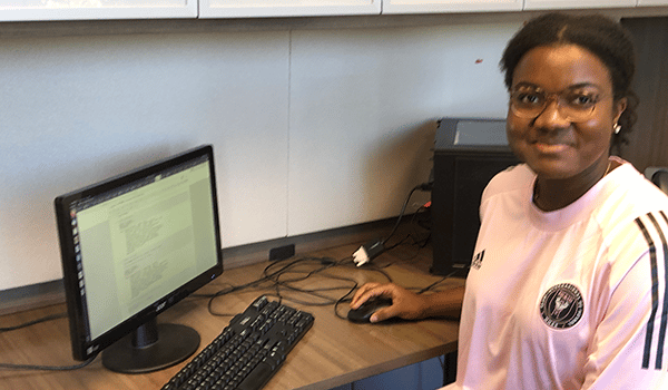 a person standing in front of a computer