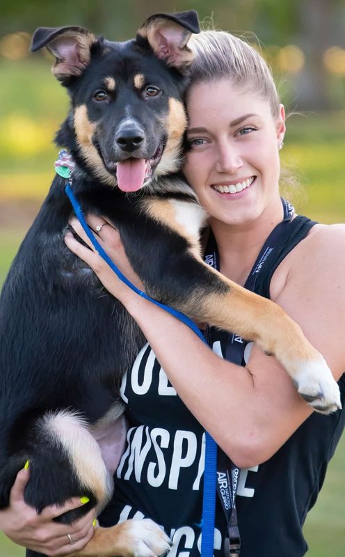 A Woman Holding A Dog