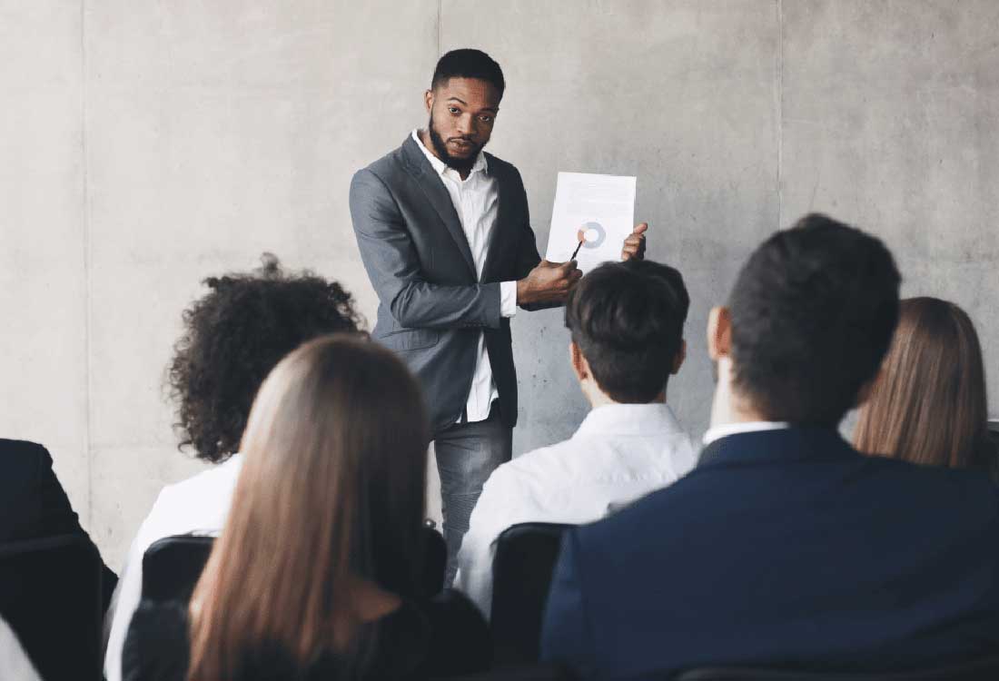 AUM classroom presentation: a man explains a chart to students during a business lecture at Auburn University at Montgomery