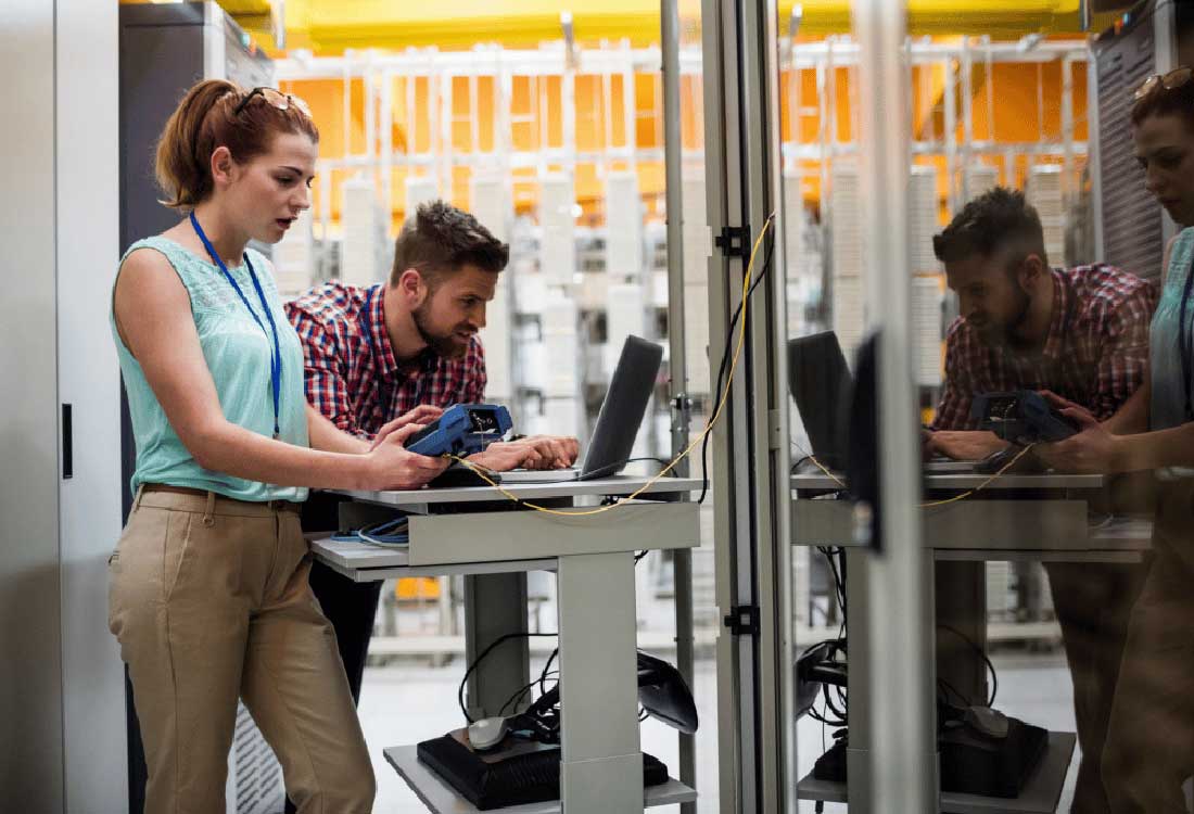 Auburn University at Montgomery a woman and a man test network equipment in a campus data center