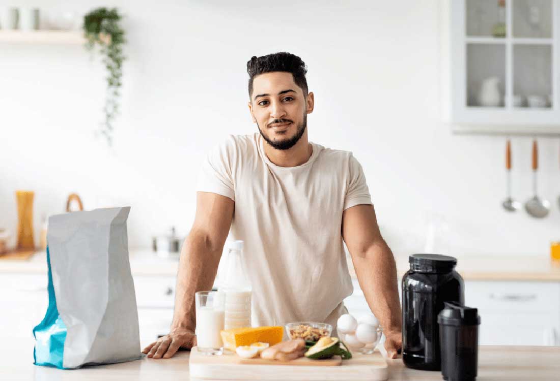 Auburn University at Montgomery student prepping high-protein meal with eggs, milk, avocado, and supplements in kitchen