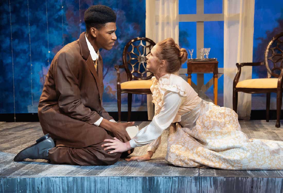 Auburn University at Montgomery theatre scene with a man and a woman in period costumes kneeling in a dramatic moment.