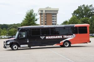 a large tour bus parked in a parking lot