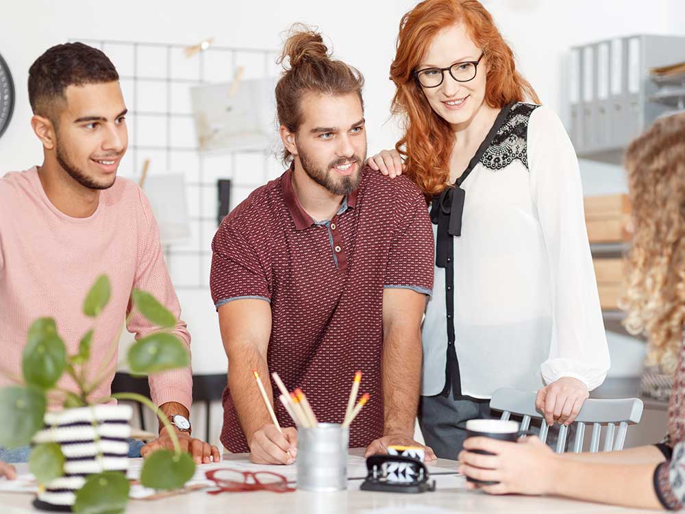 a group of people standing around a table