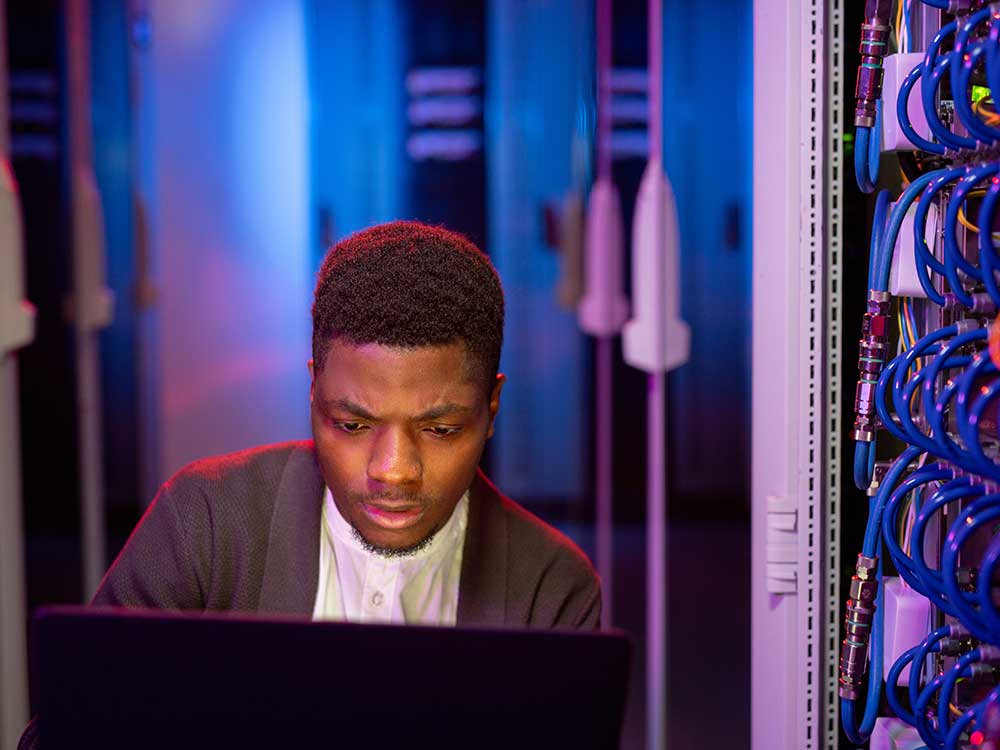 a man sitting in front of a laptop