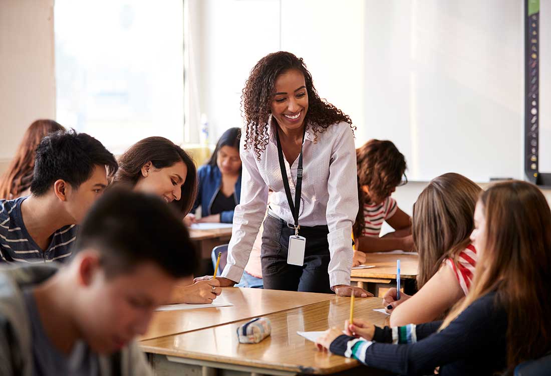 Highschool teacher working with students