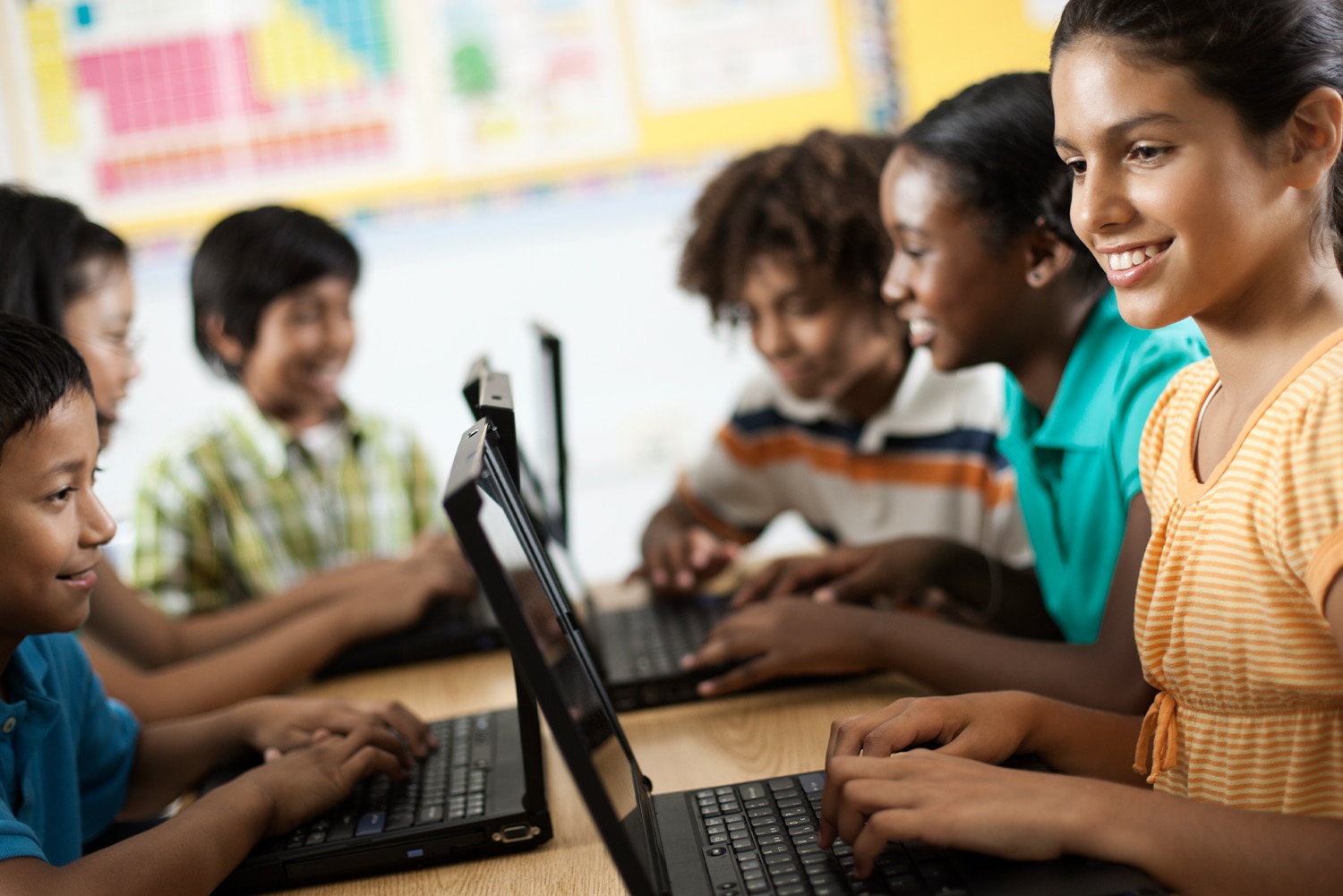 a group of people looking at a laptop