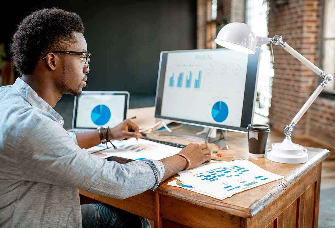 a man sitting at a table using a laptop