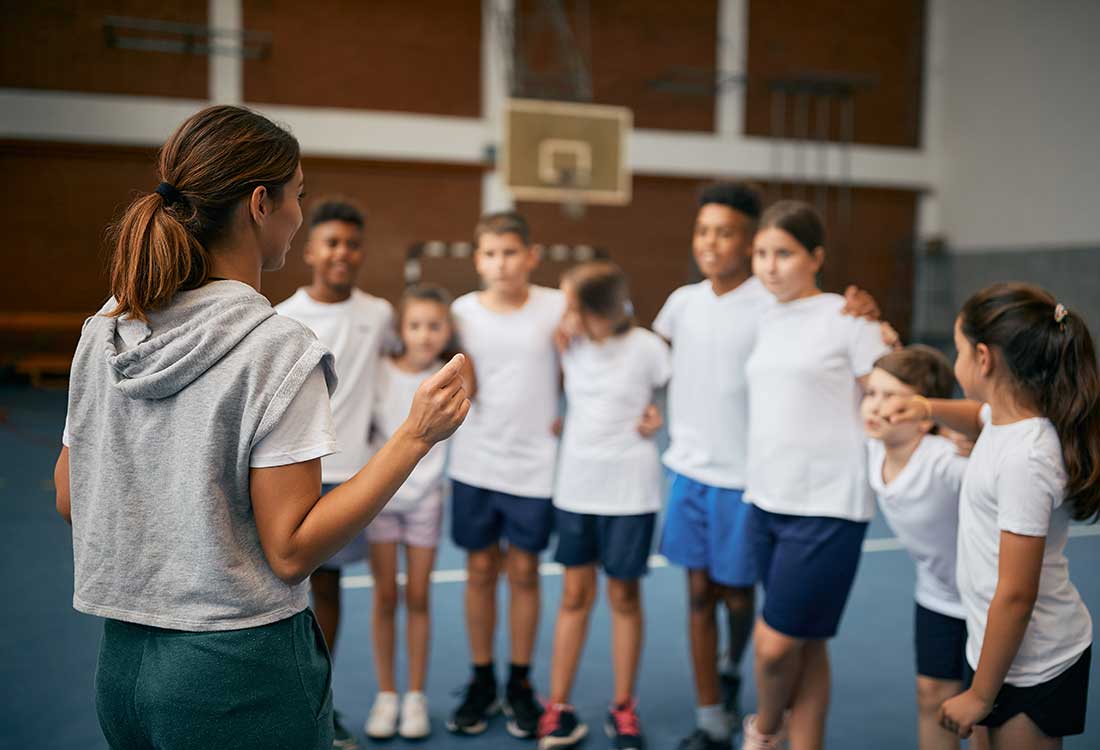 PE Coach working with young chidden