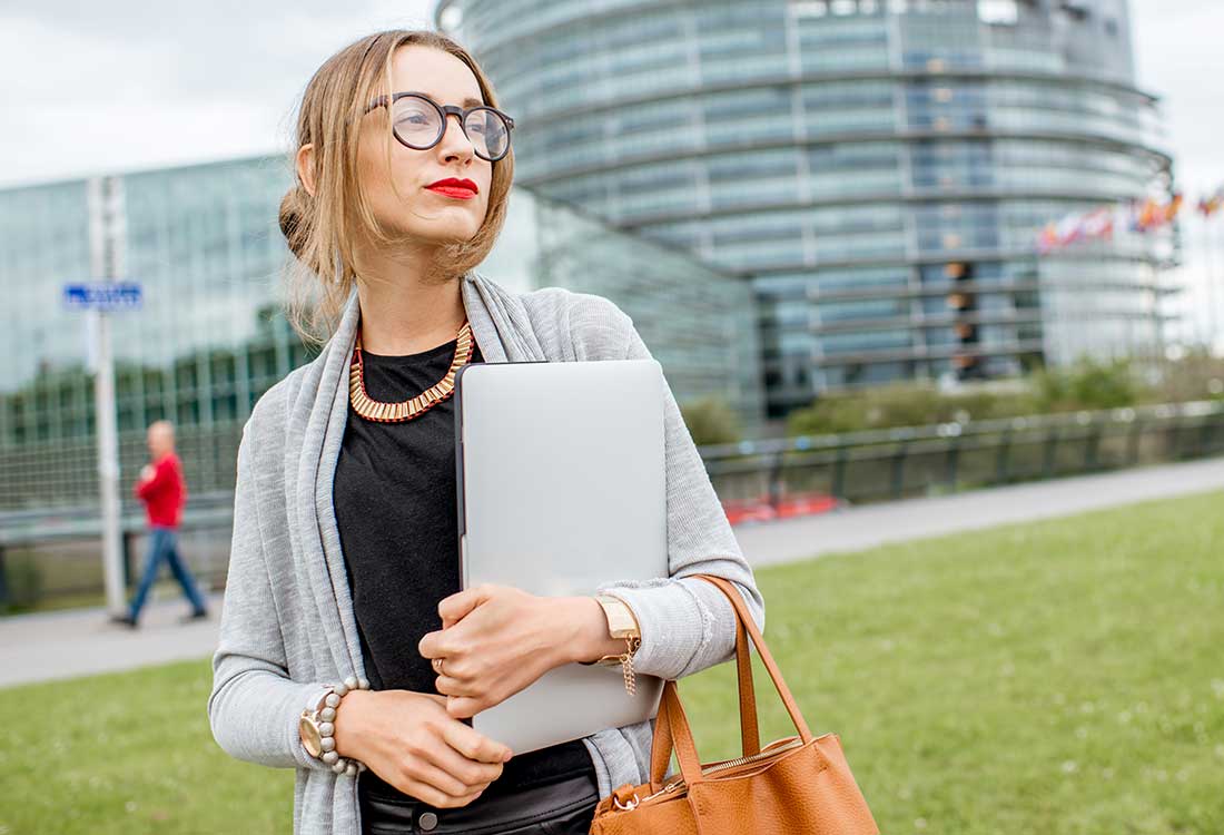 a business woman in front of a corporate office