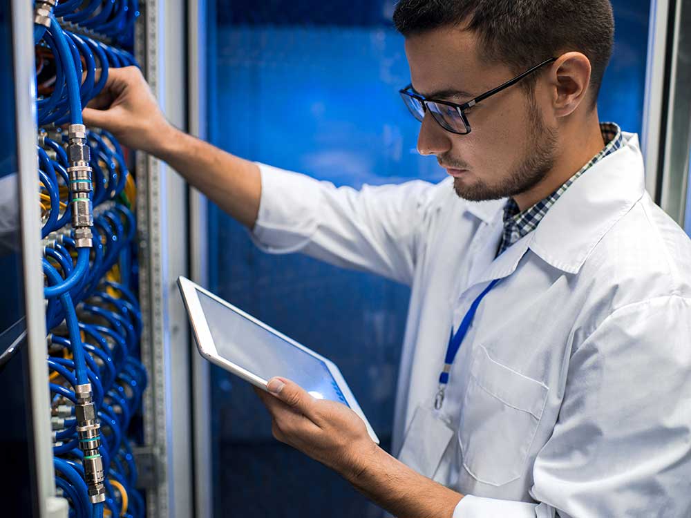 a man standing in front of a computer