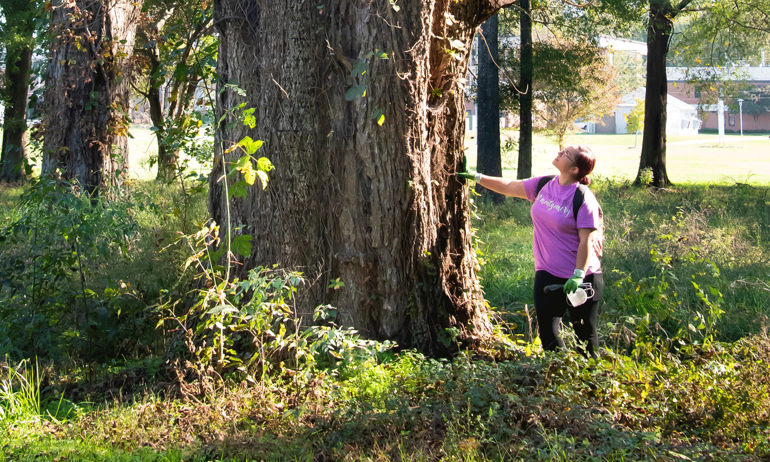 a man standing next to a tree