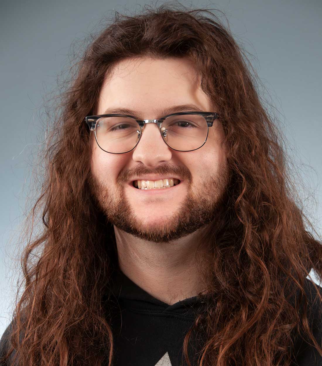 a man wearing glasses and smiling at the camera WASC Tutor