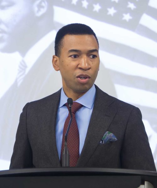 A Man Wearing A Suit And Tie