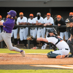 a baseball player swinging a bat at a baseball game