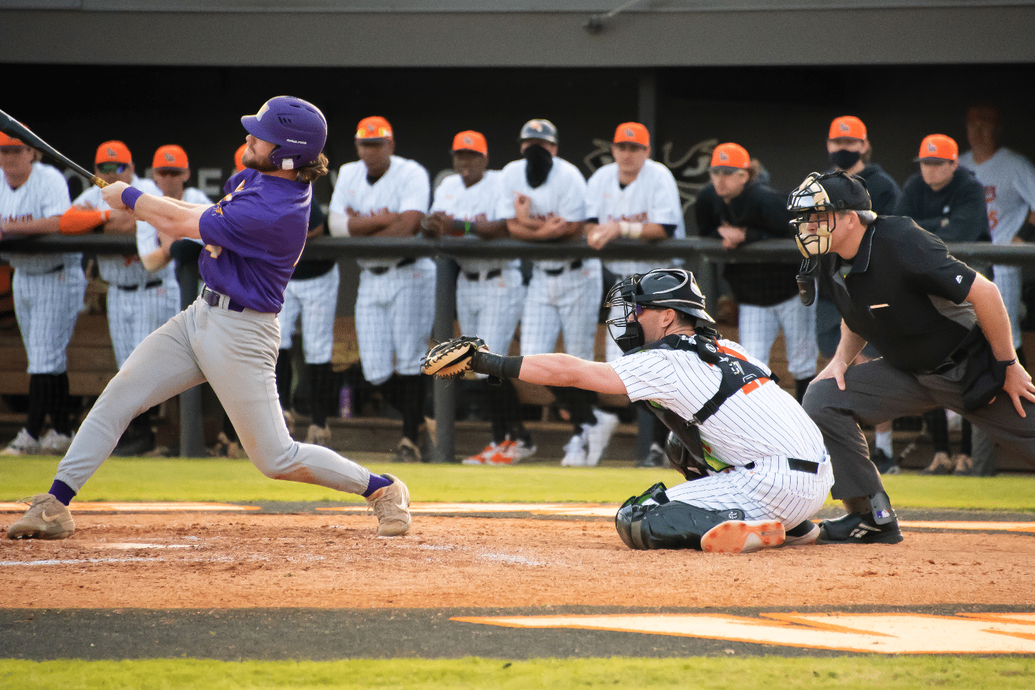 a baseball player swinging a bat at a baseball game