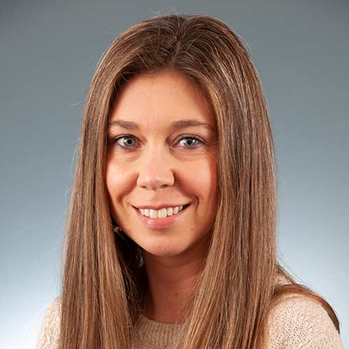 a close up of a woman who is smiling at the camera