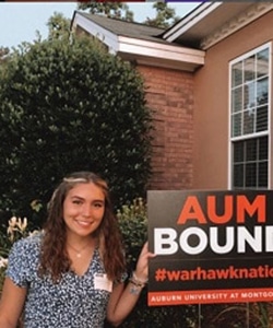 a person standing in front of a sign