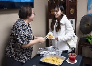 a woman cutting a cake