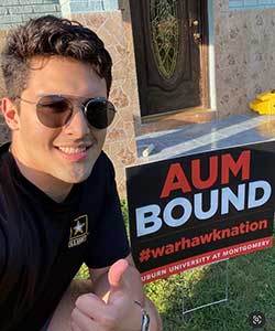 a man wearing sunglasses and holding a sign