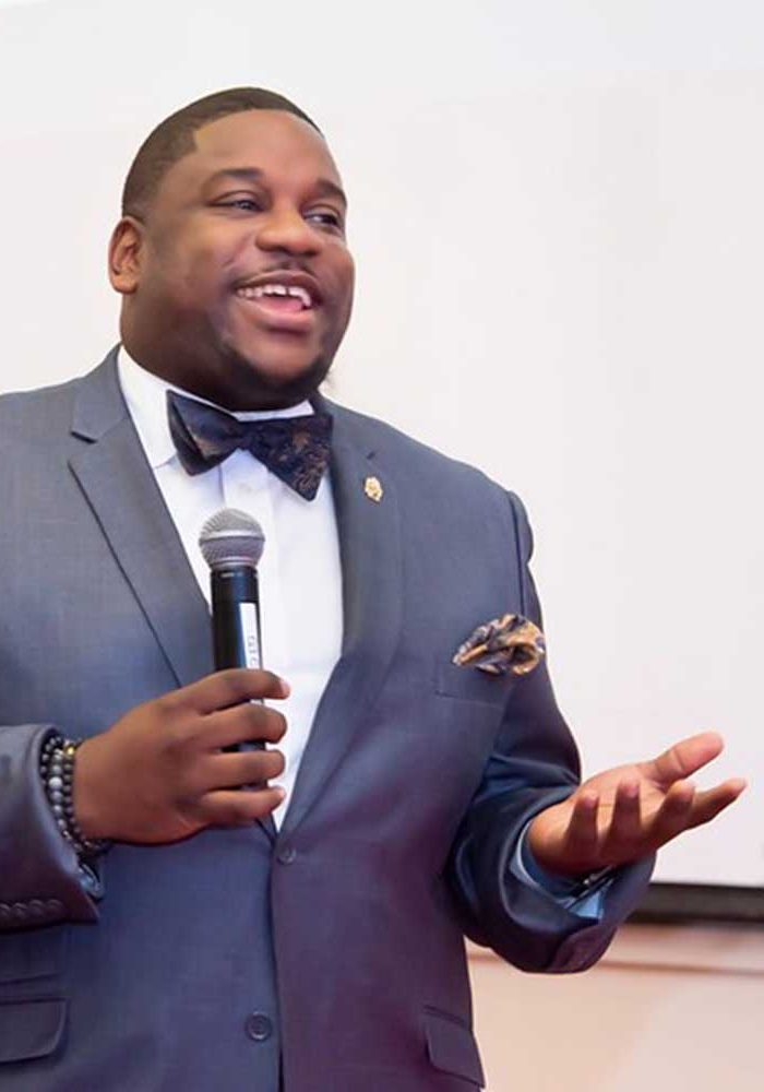 A Man Wearing A Suit And Tie