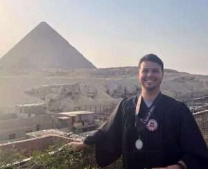 Evan Mott standing in front of a mountain in Egypt