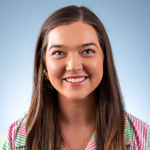 Auburn University at Montgomery student smiling in studio headshot on light blue background