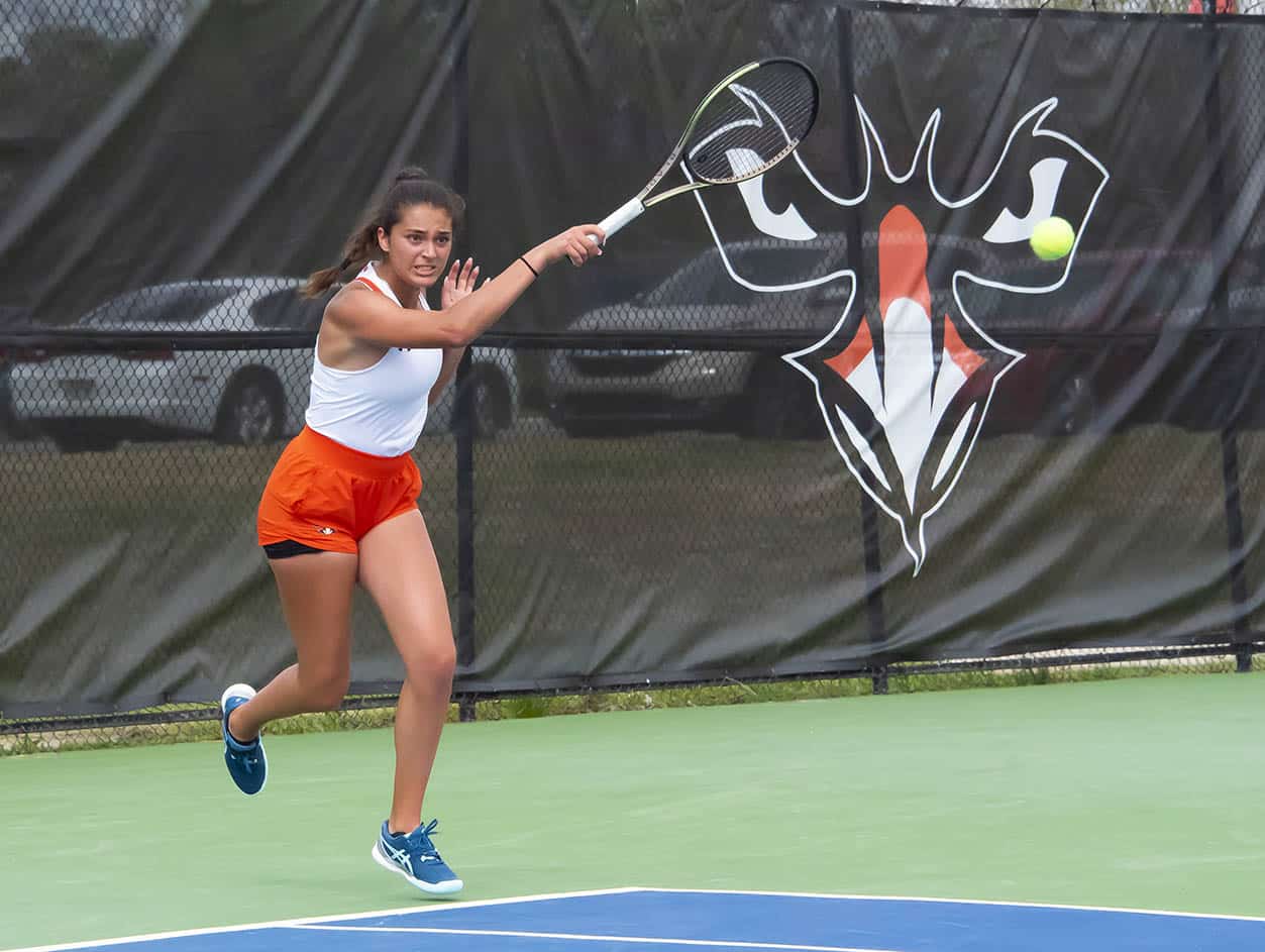 a woman hitting a ball with a racket