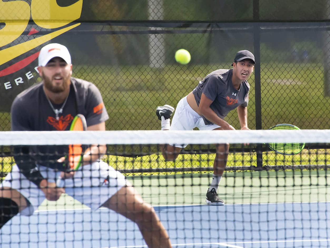 a person hitting a ball with a racket on a court