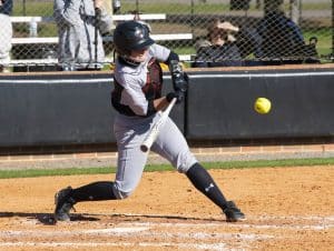 a baseball player swinging a bat at a ball