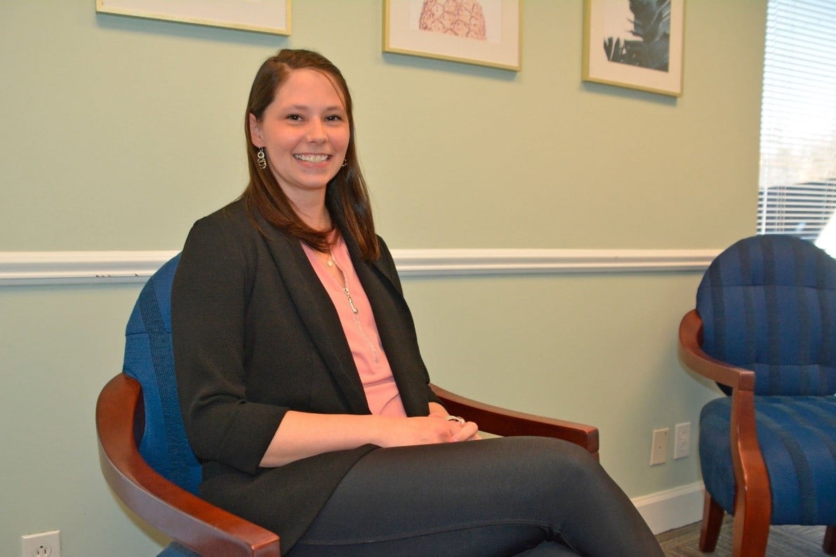 April DeLuca sitting at a desk