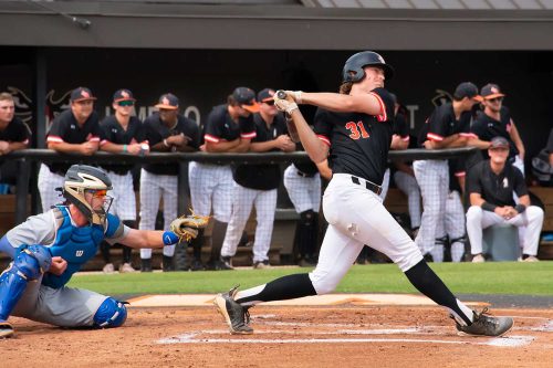 A Baseball Player Swinging A Bat At A Ball