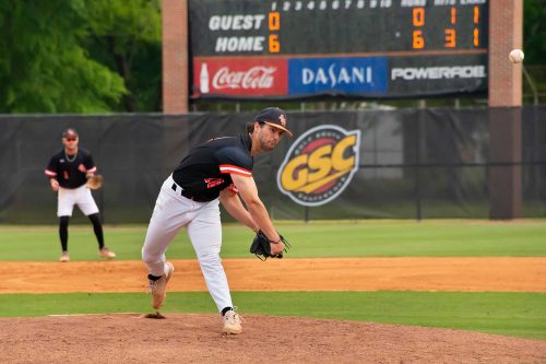 A Pitcher Throwing A Ball At A Baseball Game