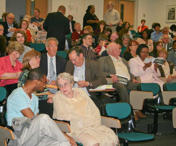 A Group Of People Sitting At A Table