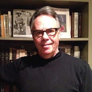 A Man Holding A Book Shelf