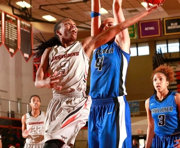 a basketball player jumping up to catch a ball